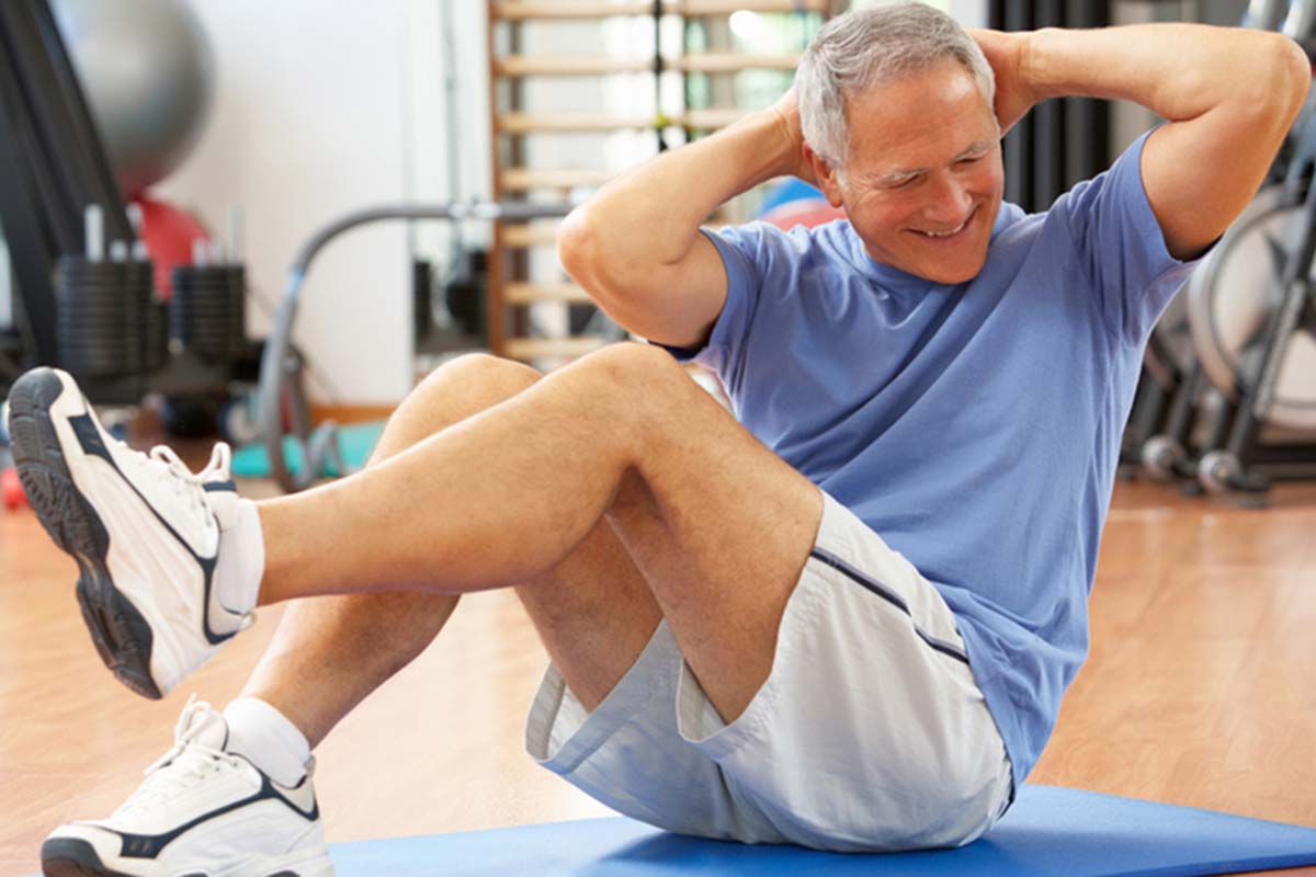 Senior Man Doing Sit Ups In Gym Integrated Health Clinic